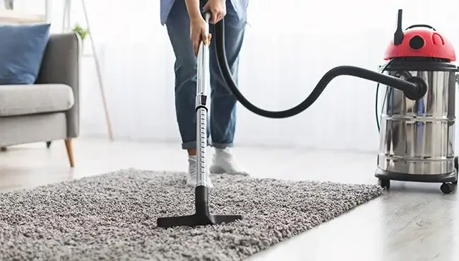 Lady cleaning rug | BC Flooring Outlet