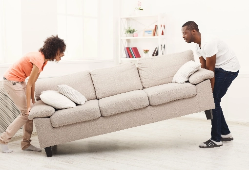 Couple moving sofa | BC Flooring Outlet